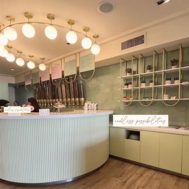 A café counter with globe lights and a curved white bar
