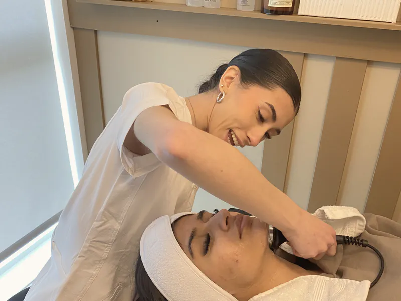 A skin specialist giving a facial treatment